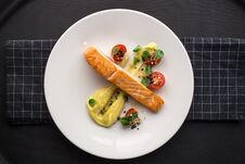 Grilled Salmon Fillets With Potato Mash And Tomatoes On Stone Board On Black Background Stock Images