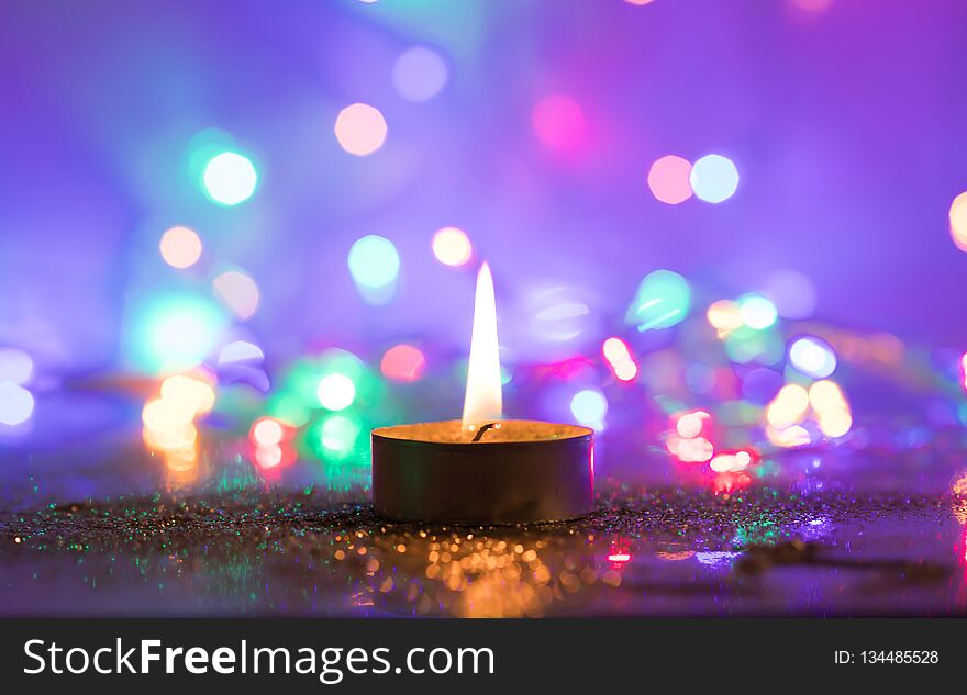 Magic Christmas candle and glittering holiday lights. Magic Christmas candle and glittering holiday lights