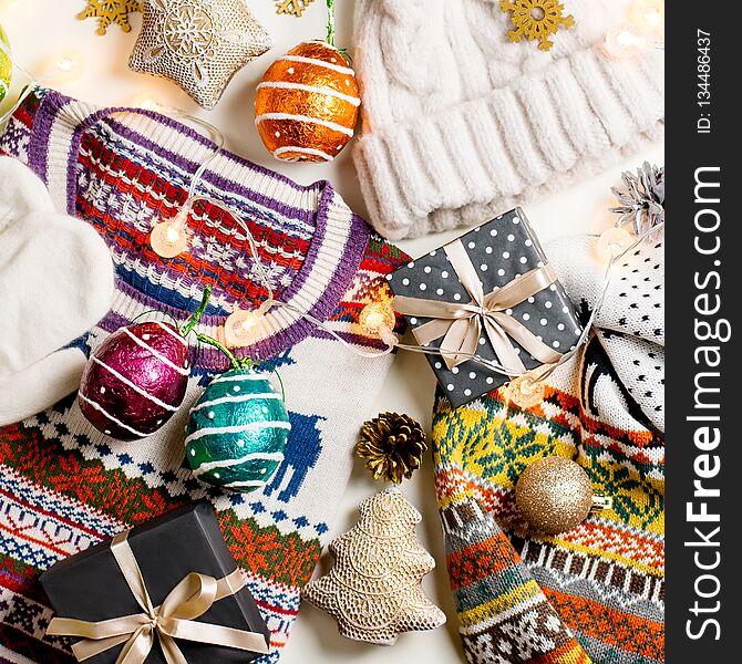 Christmas Mood Composition With Christmas Sweater, Hat, Presents And Lights. Winter Concept Flat Lay, Top View