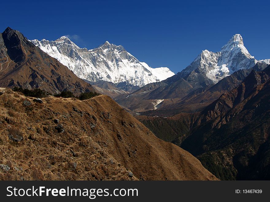 Ama Dablam peak 6812m on the right, Everest and Nuptse on the left, photographed in high Himalaya, Nepal. Ama Dablam peak 6812m on the right, Everest and Nuptse on the left, photographed in high Himalaya, Nepal