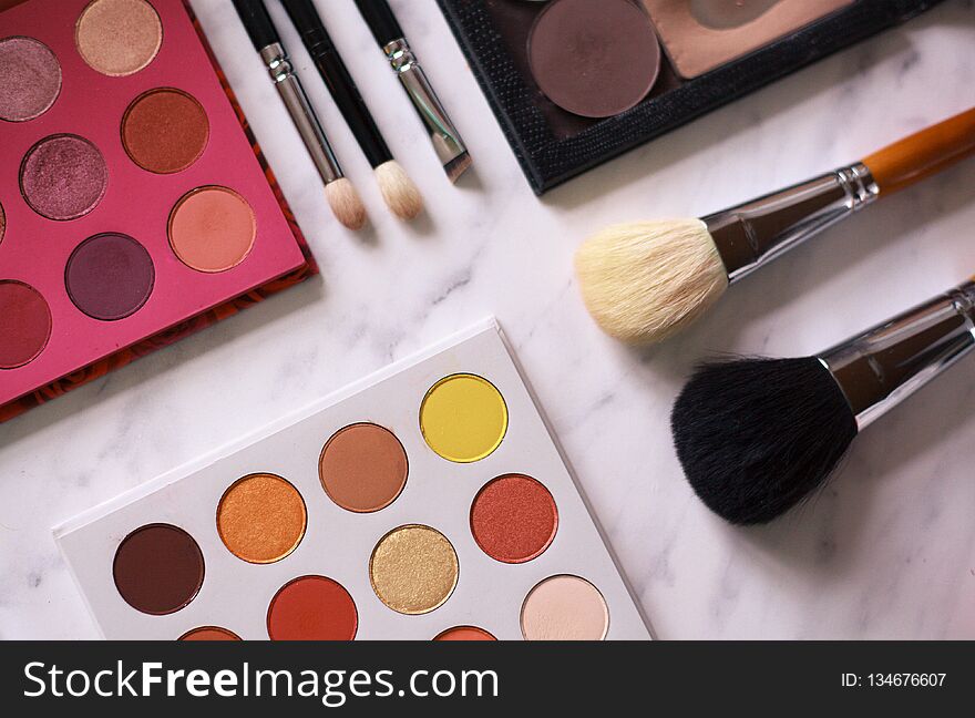 Make-up brushes. make-up artist workplace. trendy eye shadow colors. colorful palettes. basic make-up colors. top view. Make-up brushes. make-up artist workplace. trendy eye shadow colors. colorful palettes. basic make-up colors. top view