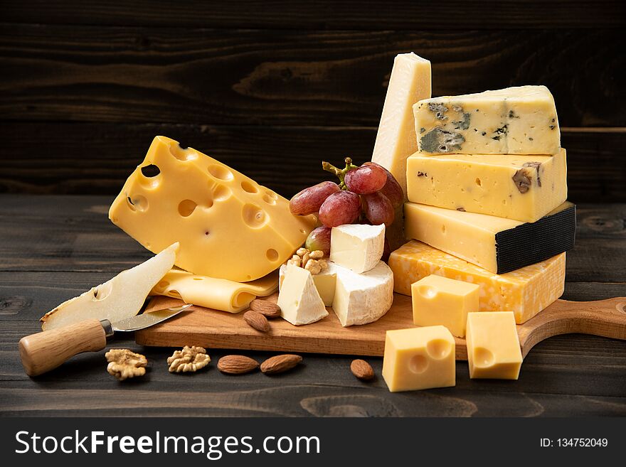 Various types of cheese on a rustic table