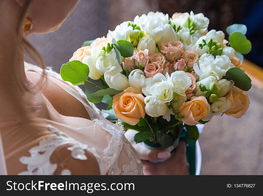 Wedding bouquet bride behind. holds beautiful her back