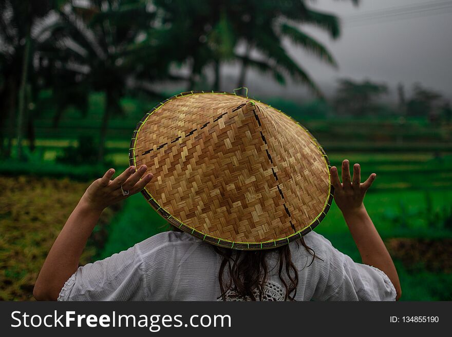 Beautiful Young Woman In Shine Through Dress Touch Asian, Vietnam Rice Hat. Girl Walk At Typical Asian Hillside With Rice Farming