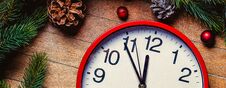 Christmas Decoration And Little Alarm Clock Near Pine Branch Royalty Free Stock Image