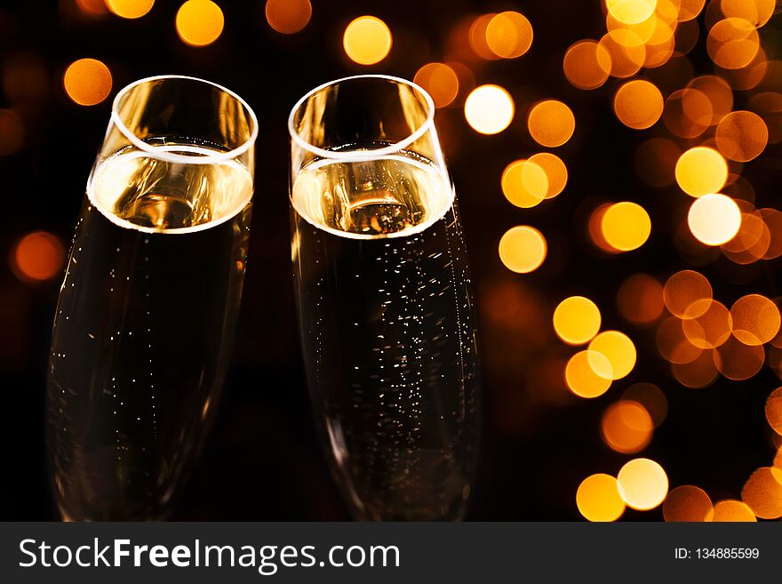 Two glasses of champagne on black stylish background. Place