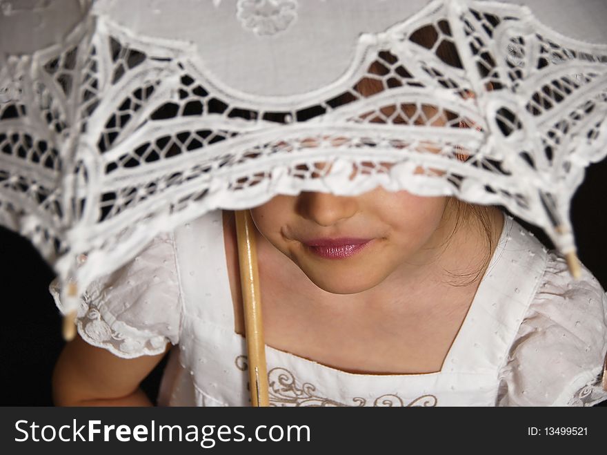 Smiling girl in the white dress with the retro umbrella on the brown background. Smiling girl in the white dress with the retro umbrella on the brown background