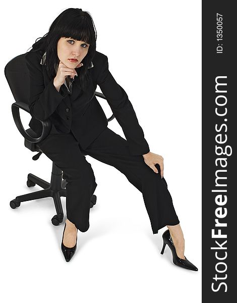Young woman in suit sitting in office chair over white. Clipping path. Young woman in suit sitting in office chair over white. Clipping path.