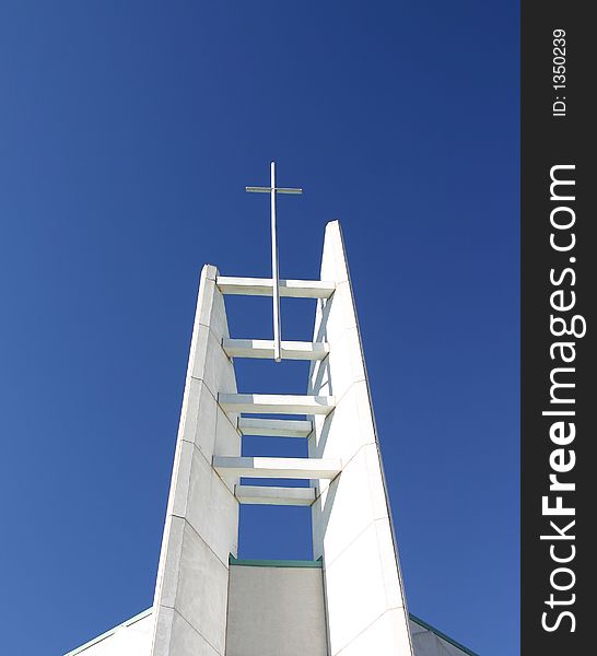 White cross stands against a blue sky