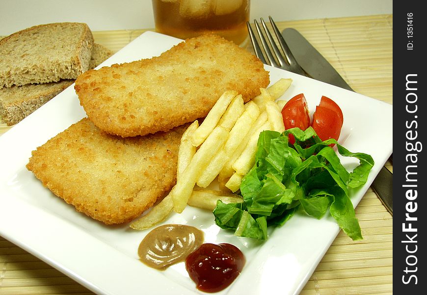 Fried traditional cordon bleu whit french and salad