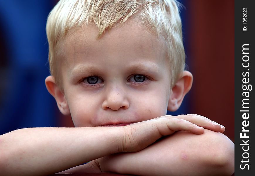 This boy has blue eyes and blond hair as he makes a silly face. This boy has blue eyes and blond hair as he makes a silly face.