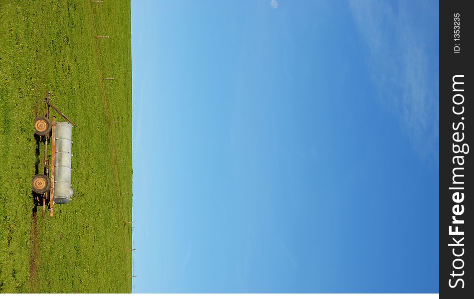 Green meadow before blue sky with drinking station for cows. Green meadow before blue sky with drinking station for cows