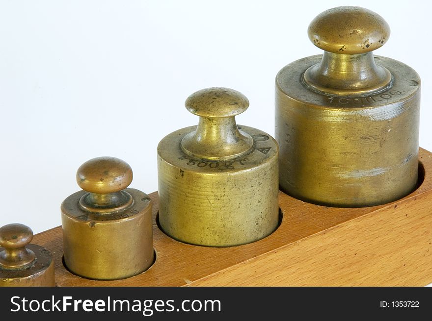 A set of lead weights in a shaped wooden box