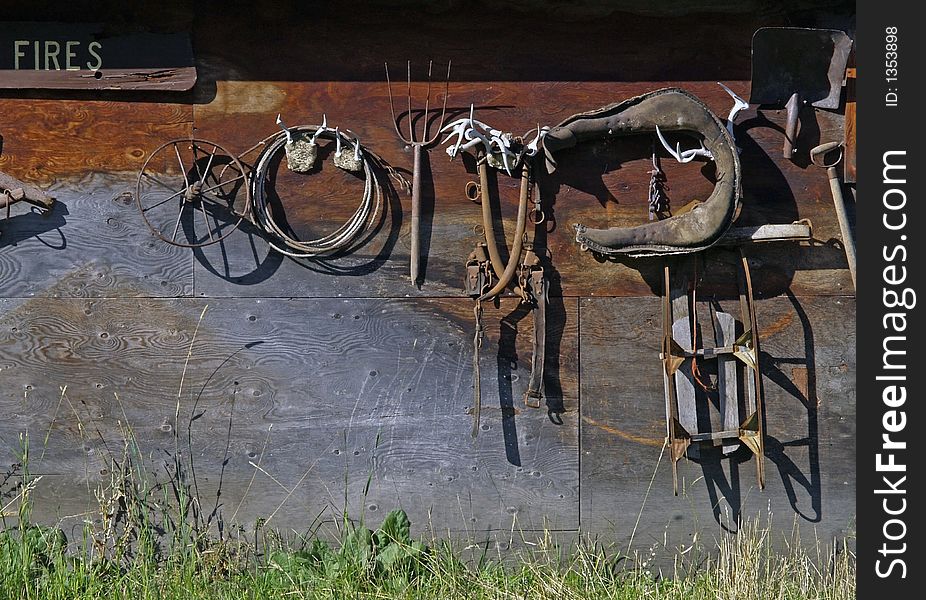 This image of the old items hanging on the outside wall of a building was taken in western MT. This image of the old items hanging on the outside wall of a building was taken in western MT.