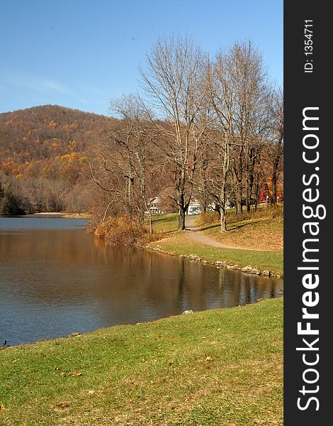 Dirt path around a lake with mountain in the background taken during the month of October (Autumn). Dirt path around a lake with mountain in the background taken during the month of October (Autumn)