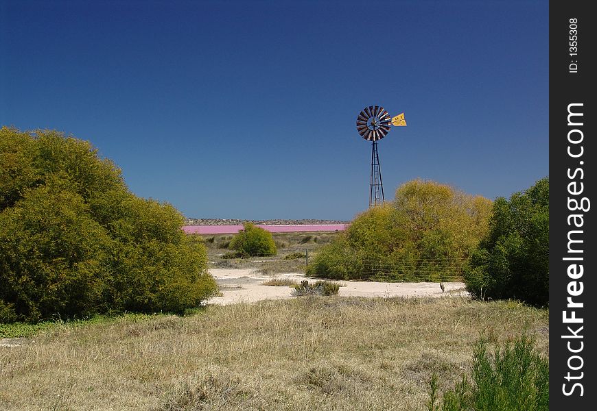 Wind-wheel before a pink-colored lagoon. Wind-wheel before a pink-colored lagoon