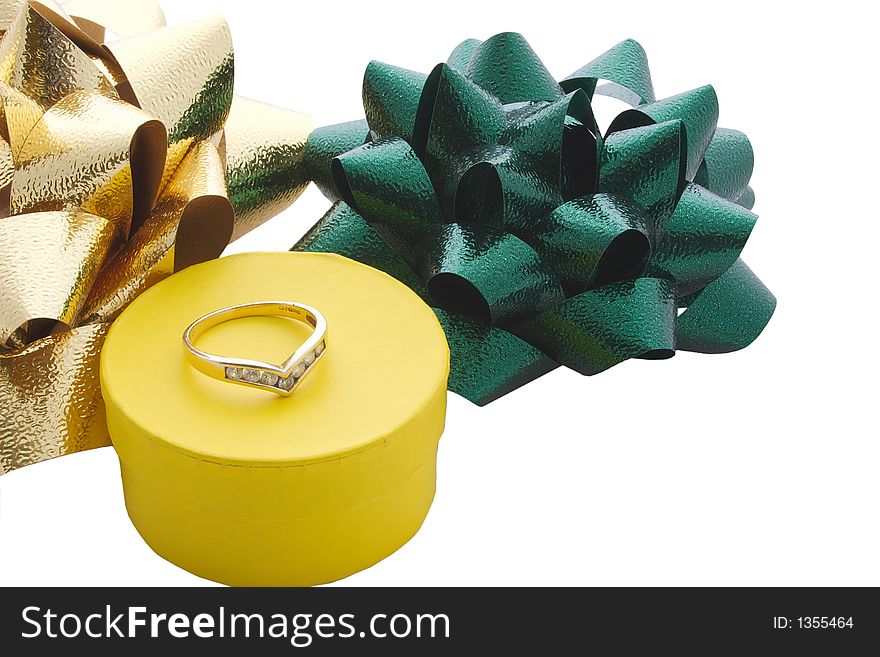 A ring on top of its gift box and ribbons isolated. A ring on top of its gift box and ribbons isolated