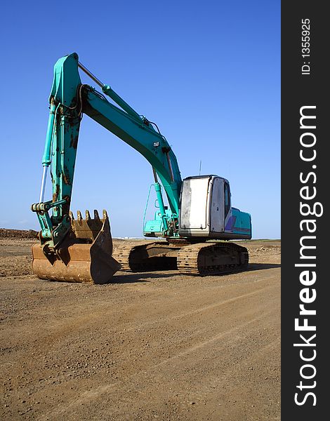 Earth mover excavator clear blue sky