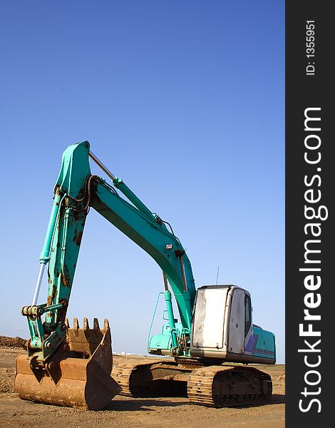 Earth mover excavator clear blue sky