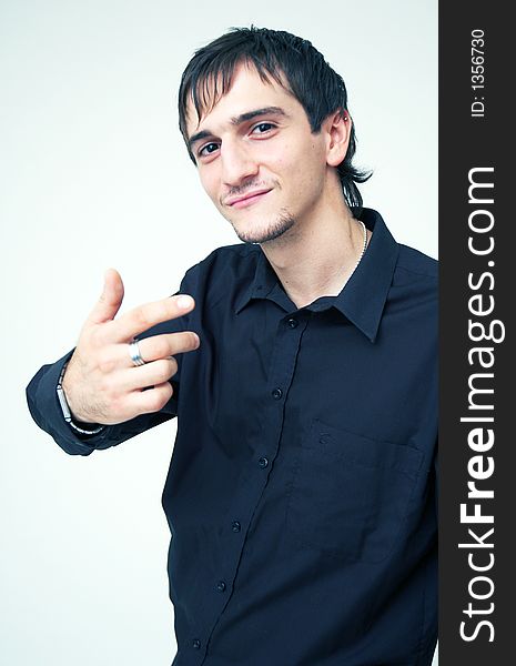 Young boy with black shirt and ring on his finger having a cool expression. Young boy with black shirt and ring on his finger having a cool expression