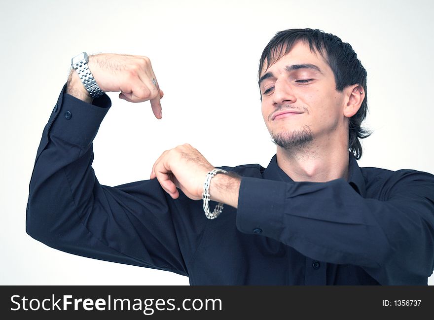 Young boy with black shirt flexing his biceps and pointing it with a finger, having a funny attitude. Young boy with black shirt flexing his biceps and pointing it with a finger, having a funny attitude