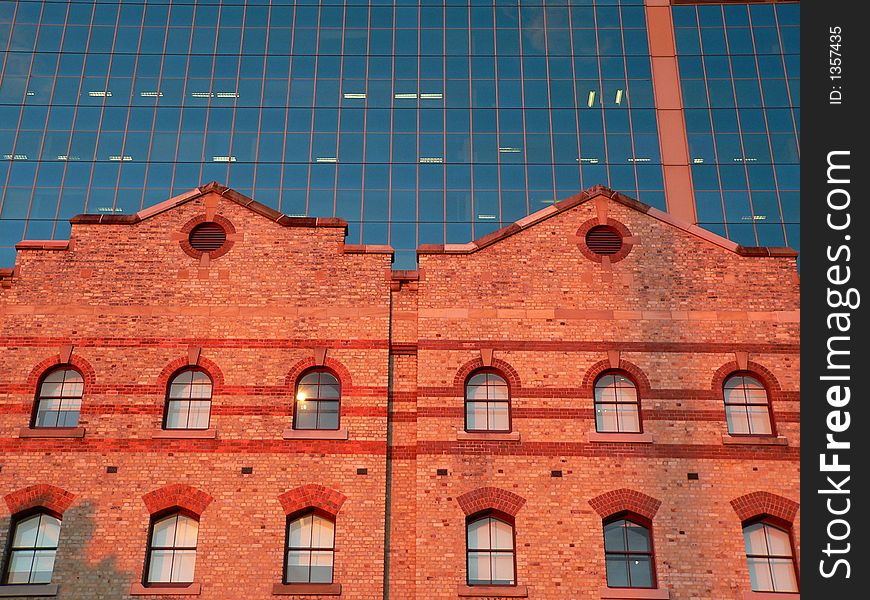 Old brick architecture in front of glass and steel architecture. Old brick architecture in front of glass and steel architecture
