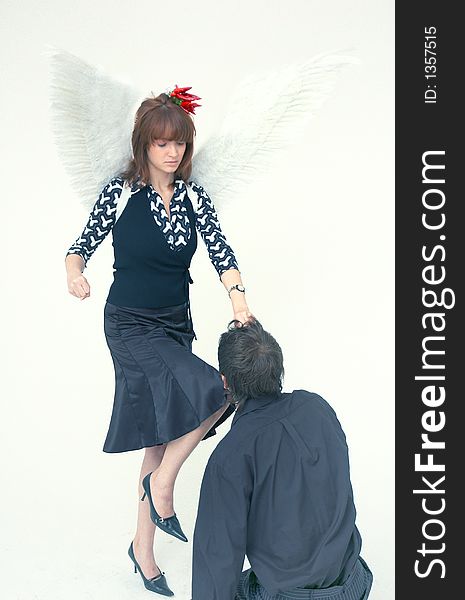 Man hands reaching a beautiful redhead girl with angel wings. Man hands reaching a beautiful redhead girl with angel wings