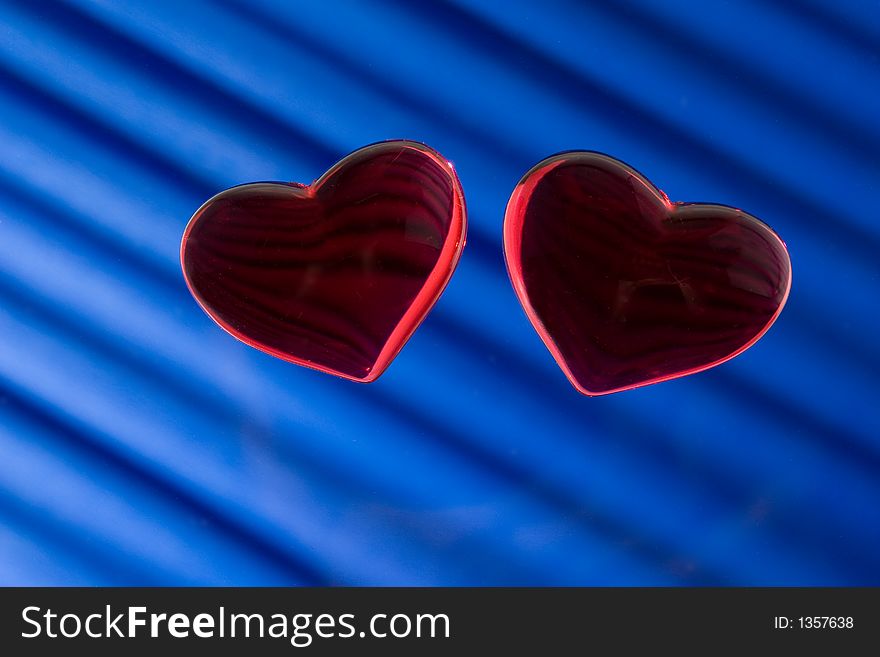 Two heart. Tho glass heart on blue background.