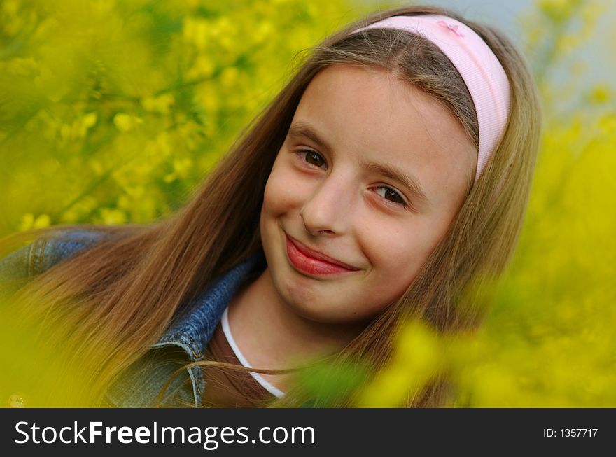 Portrait of young girl in yellow flowers