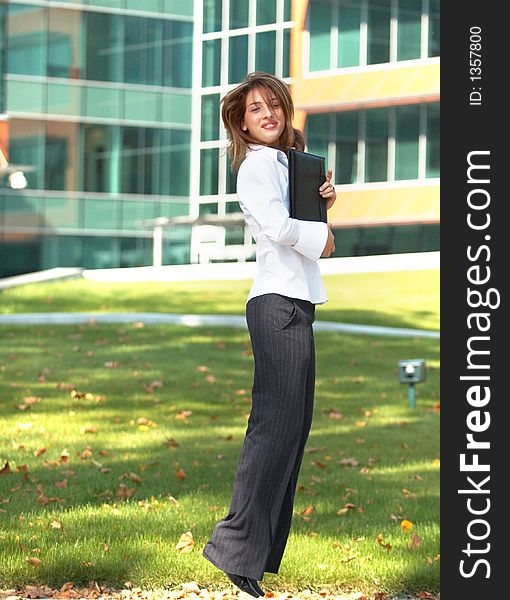 Portrait of a beautiful young girl with casual clothes holding an agenda in her hands, jumping and looking happy. Portrait of a beautiful young girl with casual clothes holding an agenda in her hands, jumping and looking happy