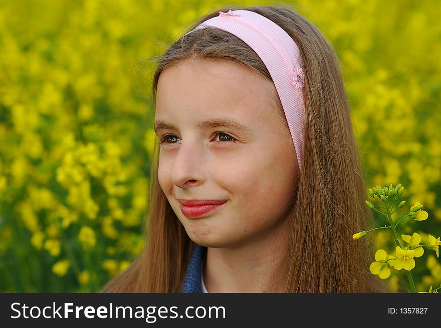 Portrait of young girl in yellow flowers