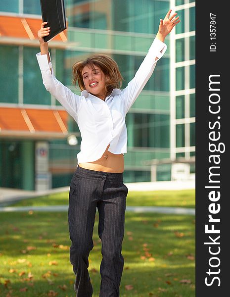 Portrait of a beautiful young girl with casual clothes holding an agenda in her hands, jumping and looking happy. Portrait of a beautiful young girl with casual clothes holding an agenda in her hands, jumping and looking happy