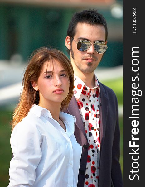 Portrait of a young business couple in a park, looking confident in their youth and abilities. Portrait of a young business couple in a park, looking confident in their youth and abilities