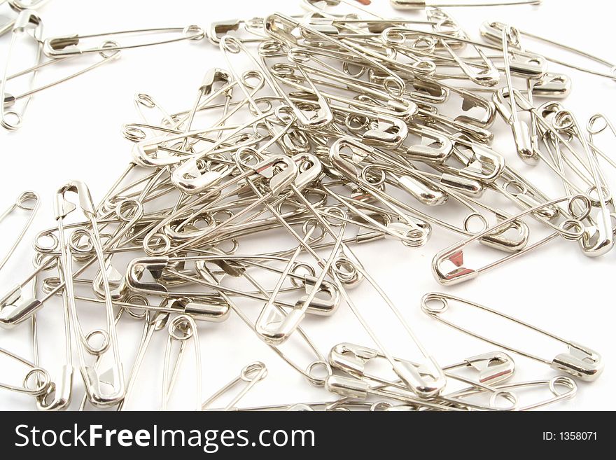 Safety pins on a white background
