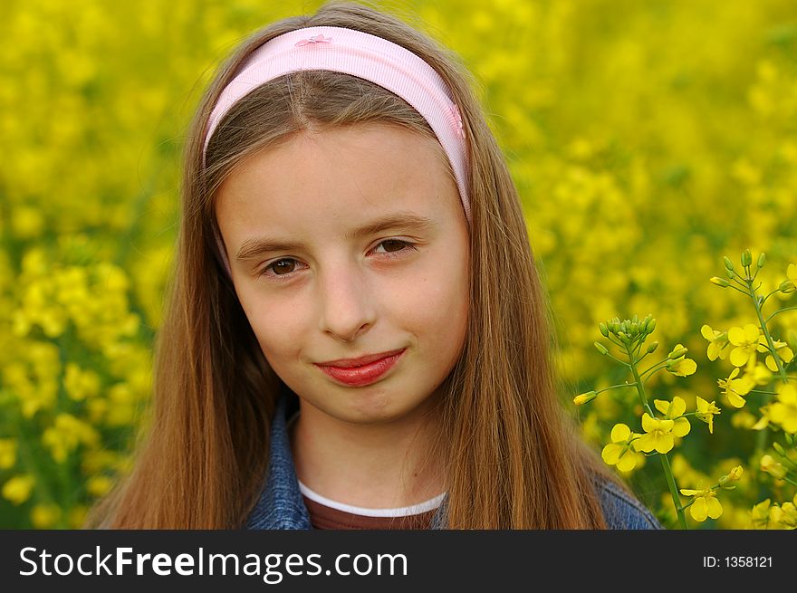 Portrait of young girl in yellow flowers