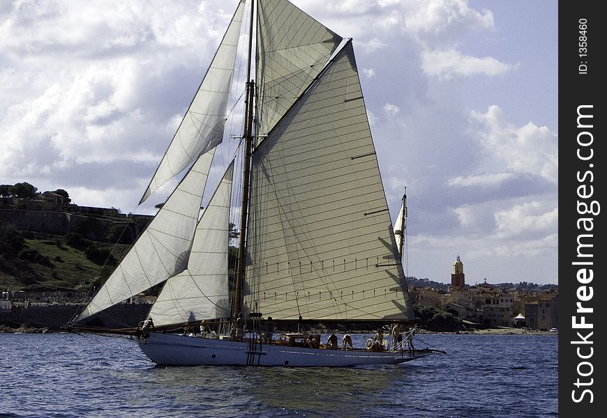 Classic sailing yacht Veronique Gliding in a light breeze at the village of St-Tropez