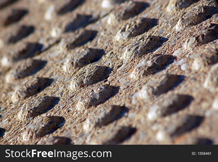 Close up of concrete bumps used in a pattern on a sidewalk to warn blind or vision impaired pedestrians of a traffic hazard such as the edge of the road at a curb ramp. Close up of concrete bumps used in a pattern on a sidewalk to warn blind or vision impaired pedestrians of a traffic hazard such as the edge of the road at a curb ramp