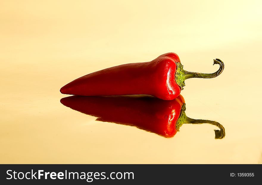 Red Chile Pepper on gold surface. Red Chile Pepper on gold surface
