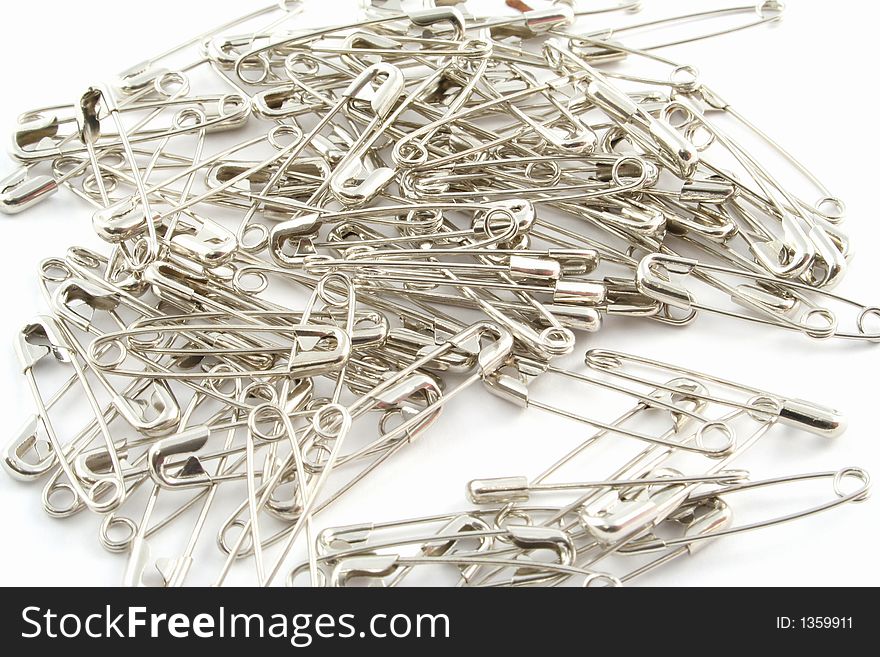 Safety pins on a white background