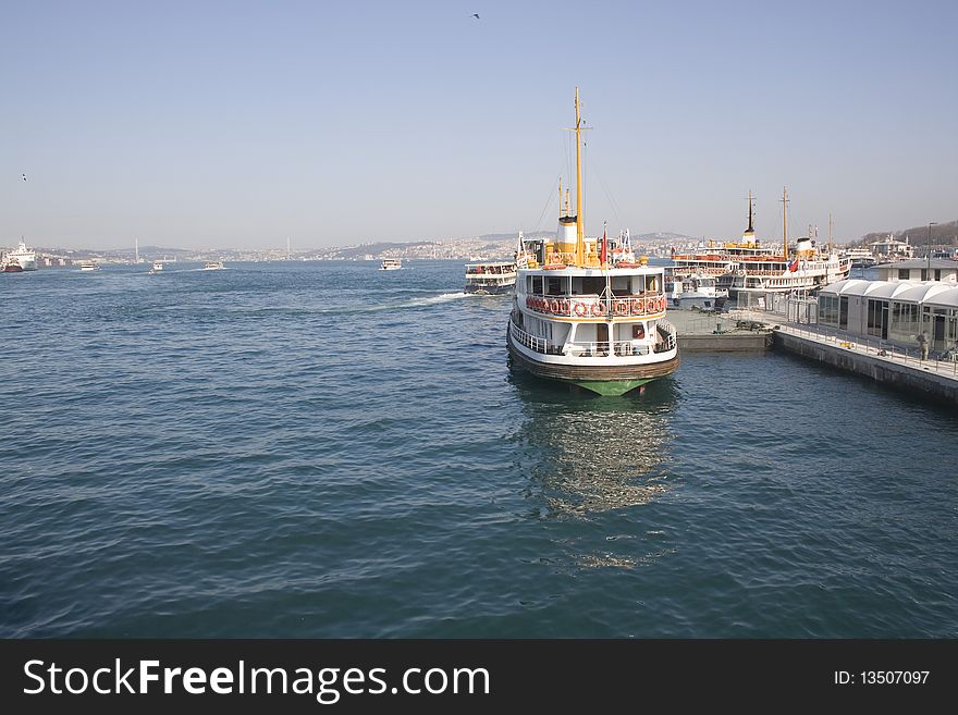 Galata bridge into the boat makes. fishermen who fish off a bridge. istanbul, turkey. Galata bridge into the boat makes. fishermen who fish off a bridge. istanbul, turkey