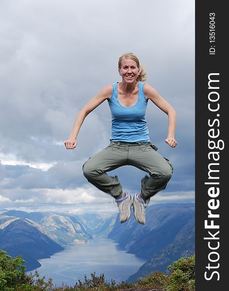 Jumping woman and Norwegian fjord landscape. Jumping woman and Norwegian fjord landscape
