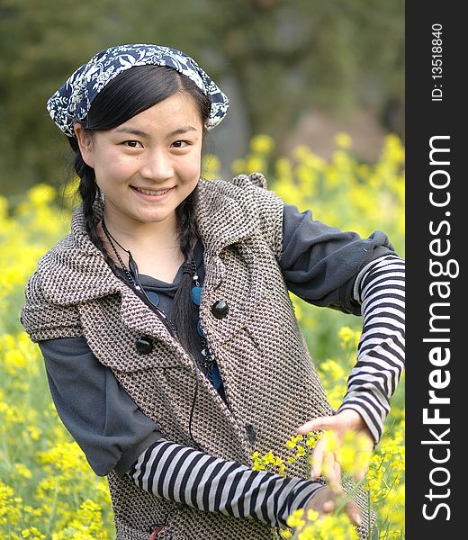 and beautiful young happy woman. In the yellow flower background. and beautiful young happy woman. In the yellow flower background
