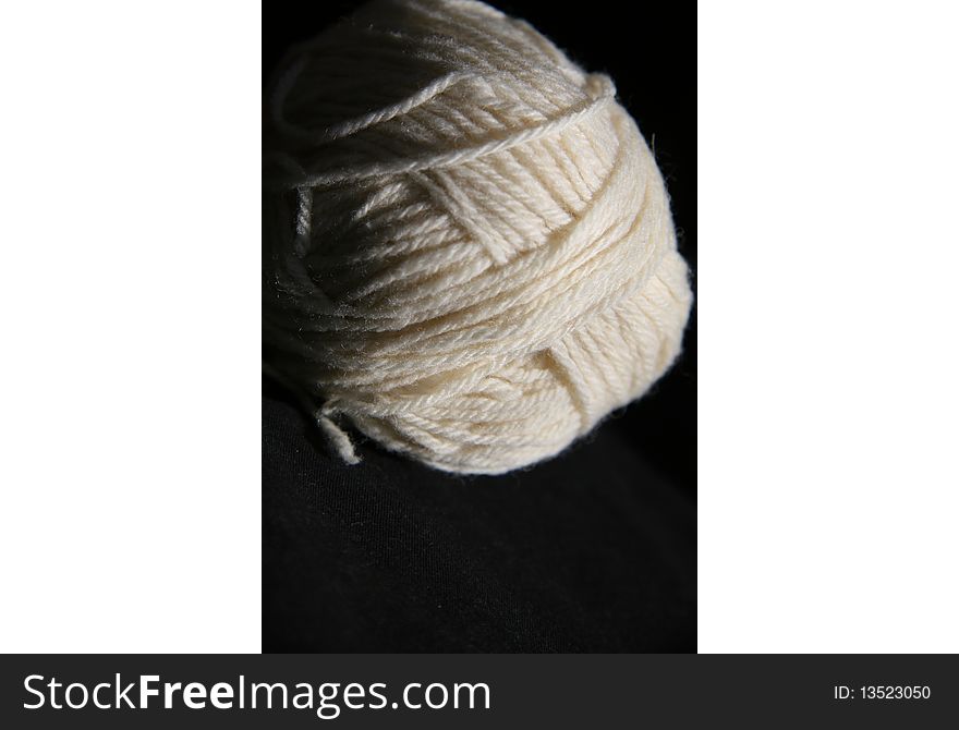 White yarn ball on black