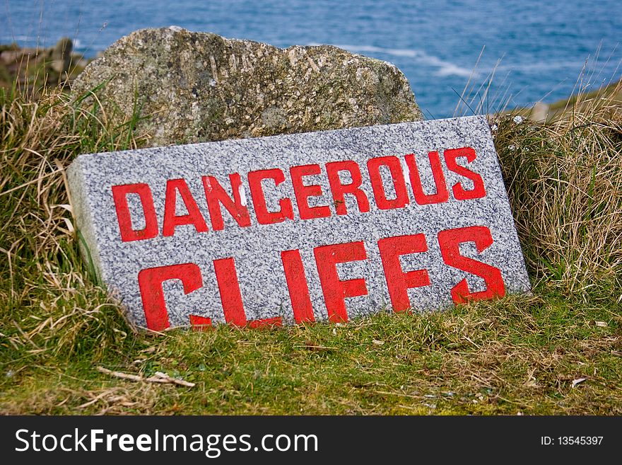 Danger sign on the cliffs overlooking lands end UK