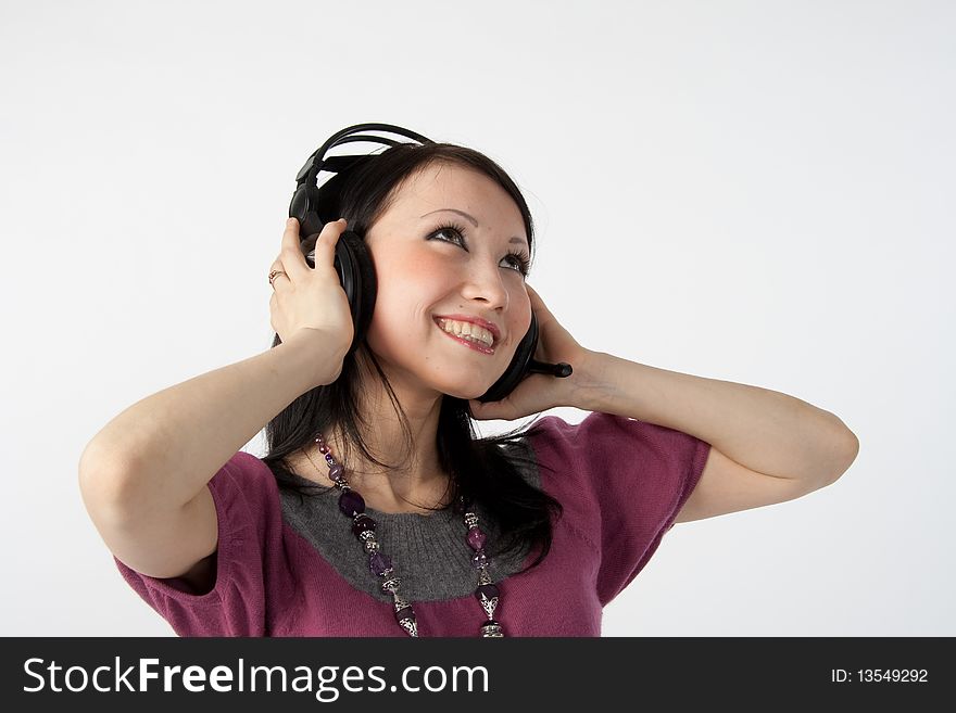 Attractive smiling woman with headphones on white background