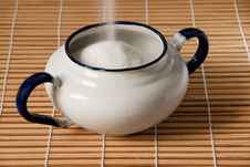 A White Enamel Sugar Bowl Being Filled Royalty Free Stock Photo A White Enamel Sugar Bowl Being Filled Royalty Free Stock Photo
