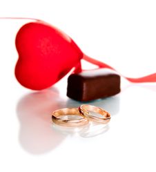 Gold Rings, Heart And Chocolate Candy Stock Photos