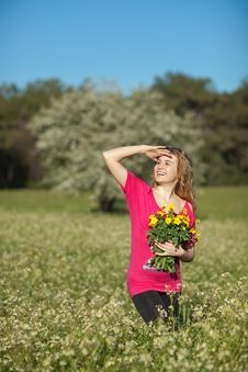Beautiful Young Woman Standing In Blooming Meadow Royalty Free Stock Images
