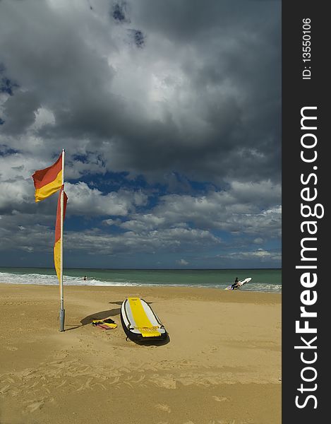 Beach with surf life saving board and flag. Beach with surf life saving board and flag