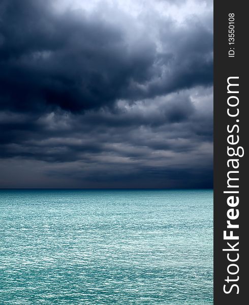 Dark clouds over turquoise sea. Dark clouds over turquoise sea.